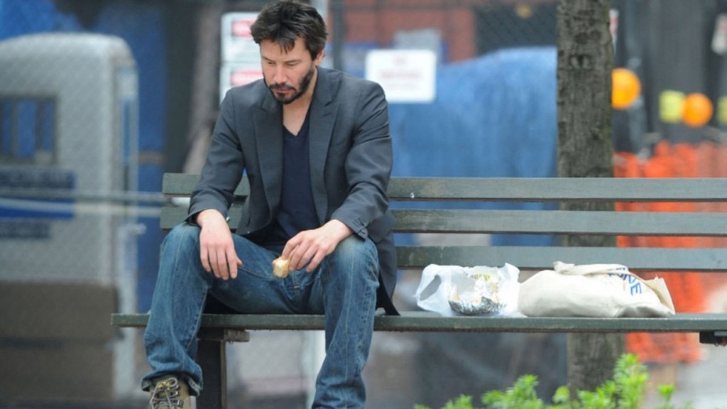 Sad Keanu sitting on a bench