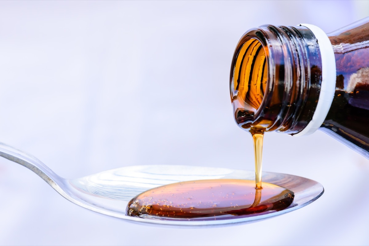 pouring liquid medicine into spoon