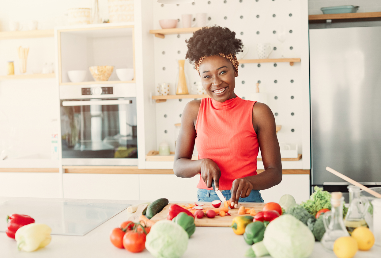 Woman preparing fruits and vegetables in the kitchen. 