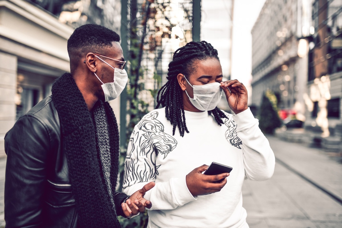 Couple Taking A Walk With Masks Because City Is Polluted