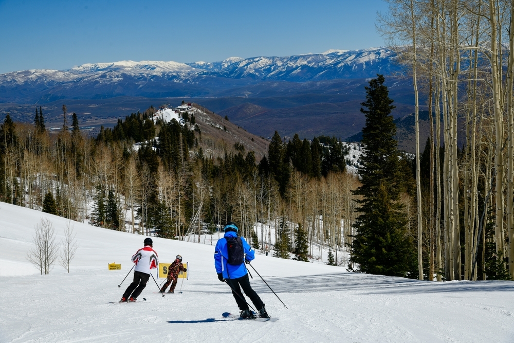 A group of skiers schussing down a slope