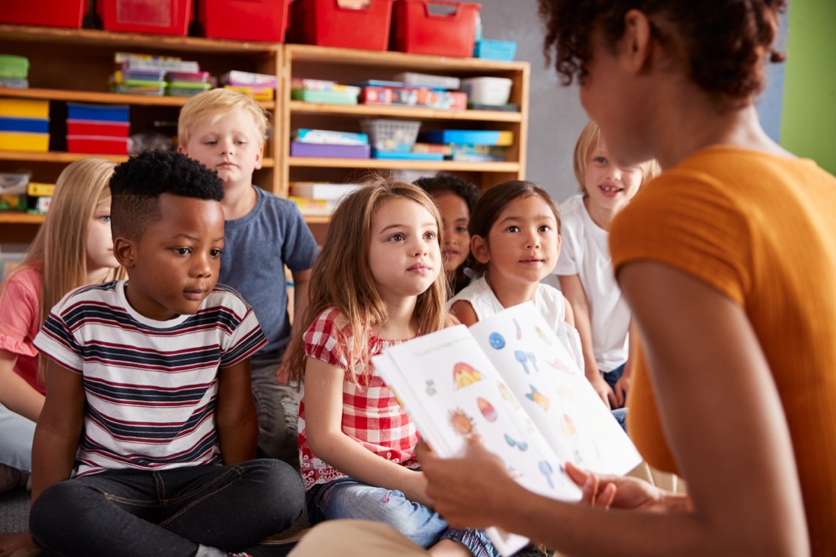 teacher and students reading book