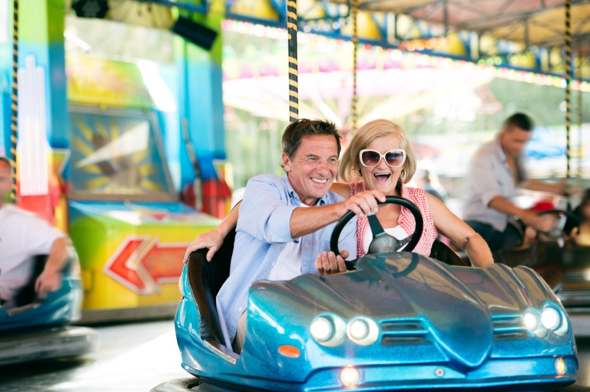 older couple riding bumper cars