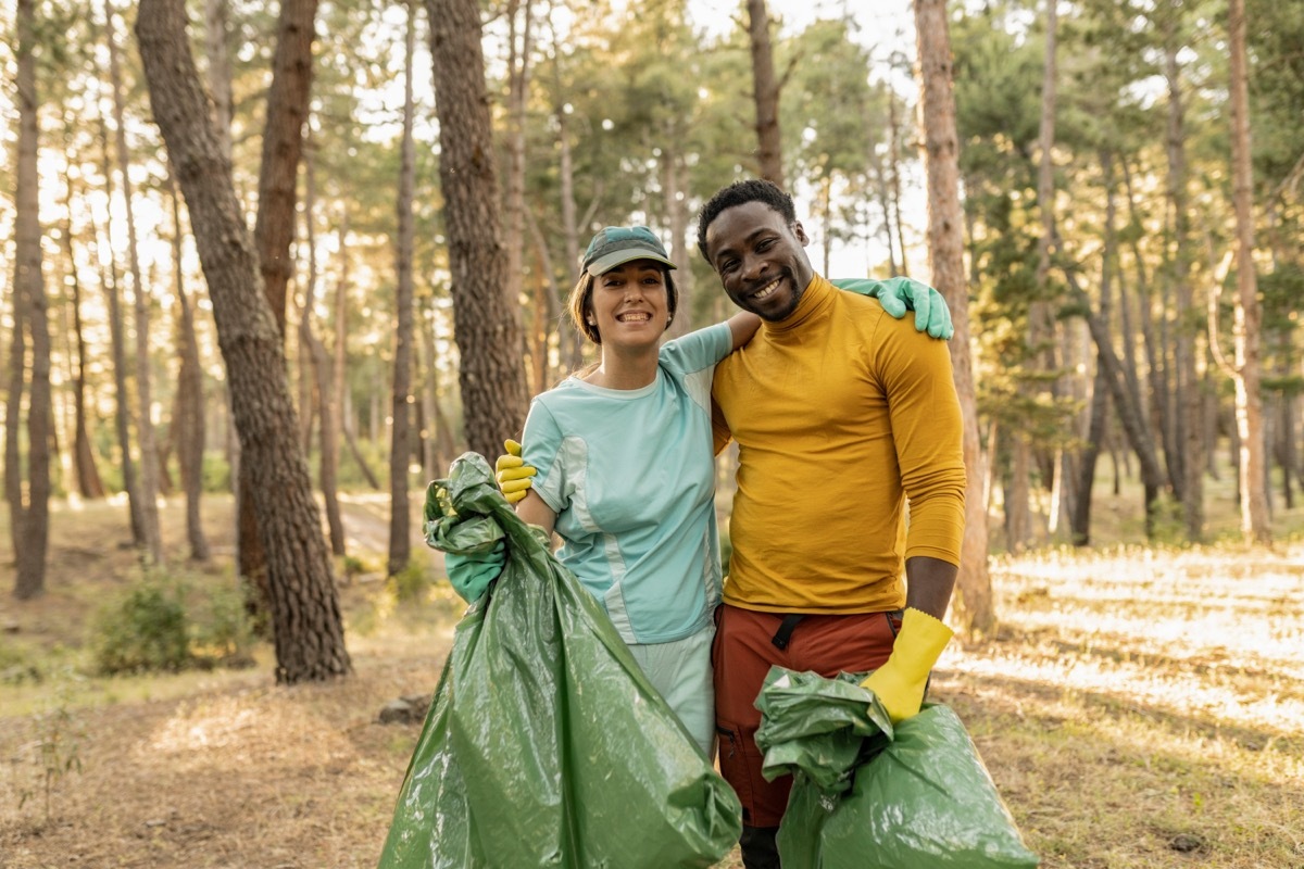 young couple volunteering at a park together