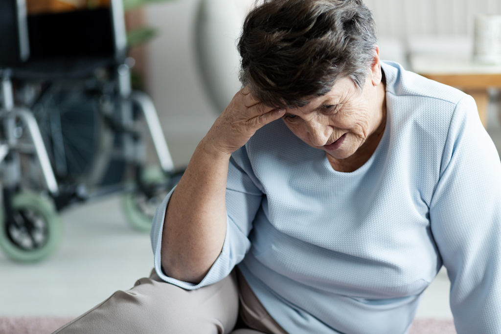 old woman fell and is holding her head