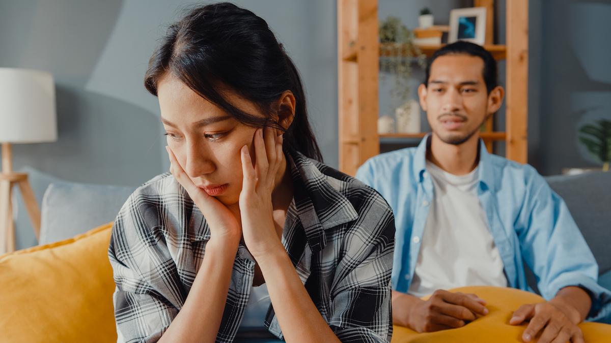 Couple on couch having a disagreement