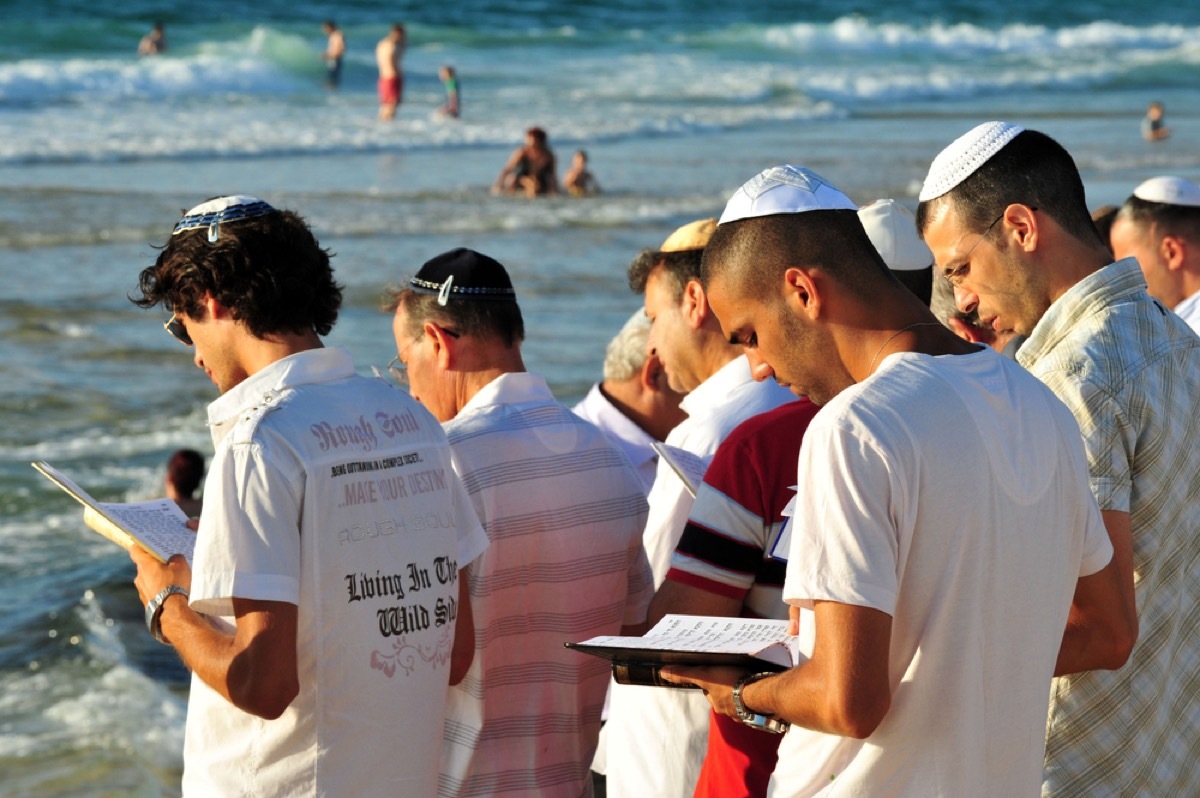 jewish men at the edge of a body of water reading torah, rosh hashanah facts