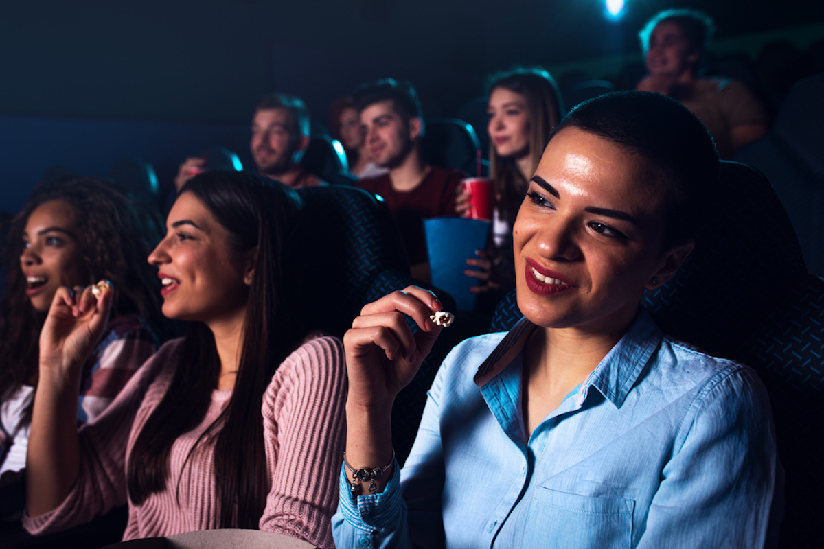 women in front row of crowded movie theater