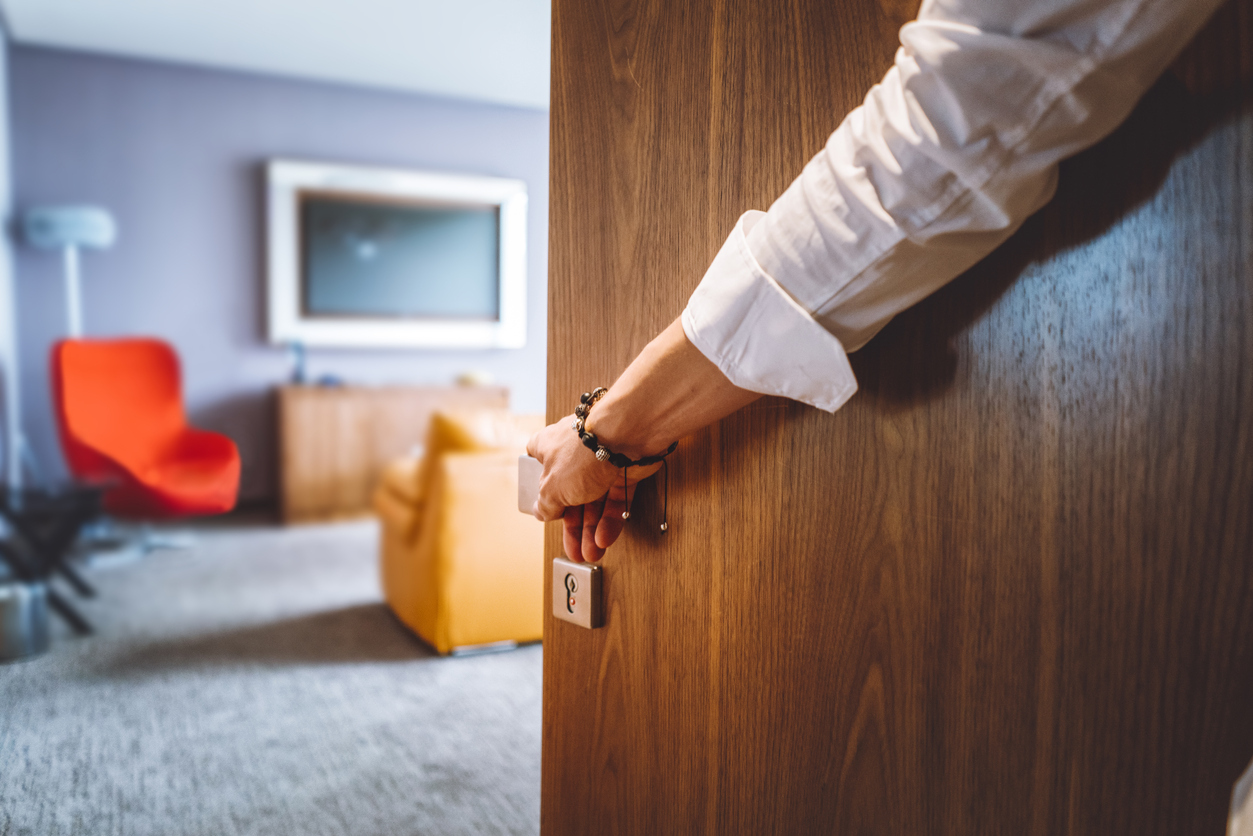 A person entering a hotel room