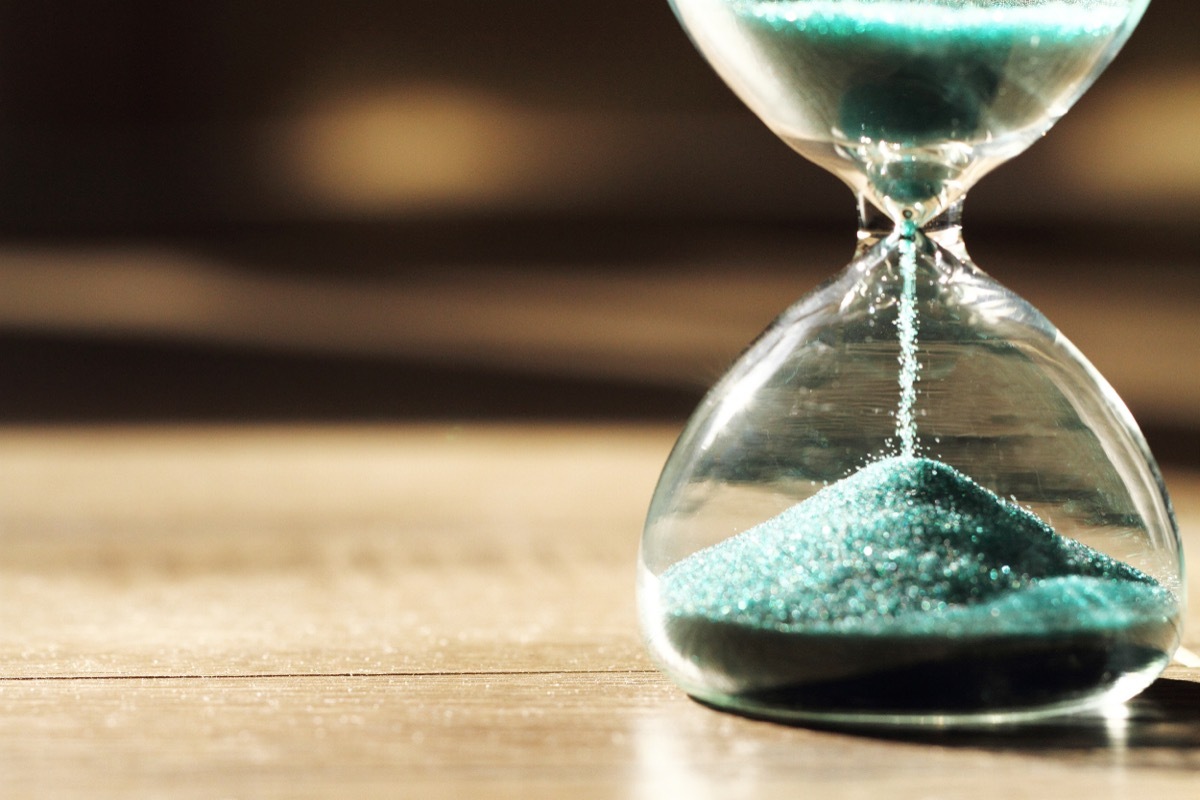 green sand running through hourglass