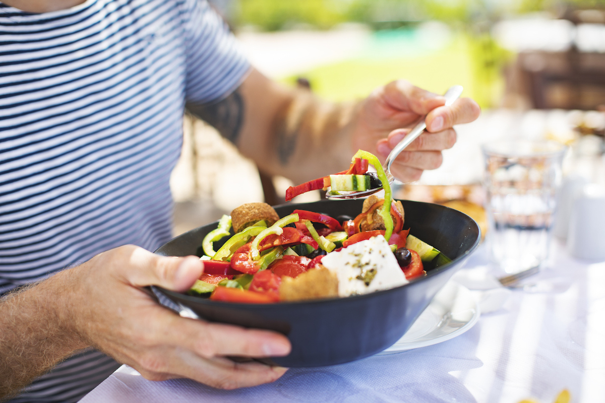 Man eating Greek Salad