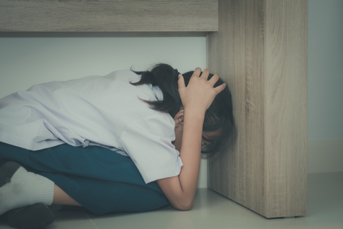 young girl hiding under desk, parenting is harder