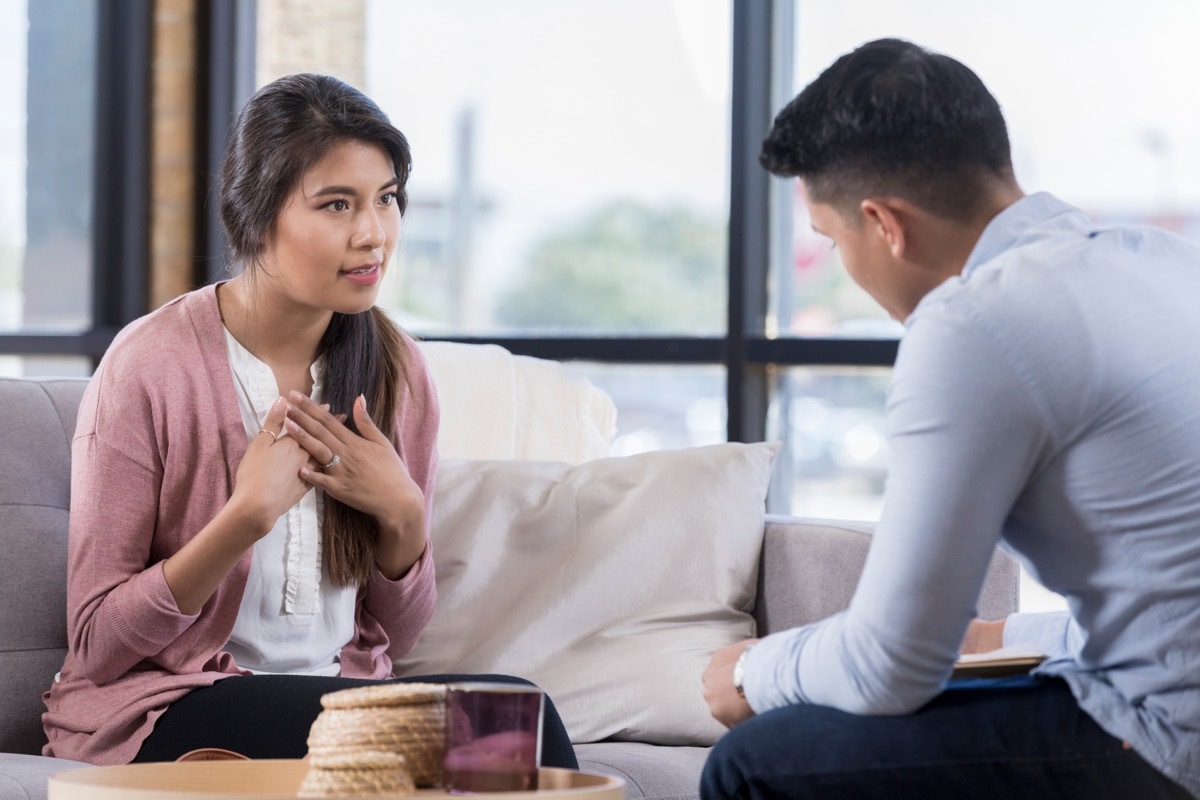 couple talking to each other on the couch