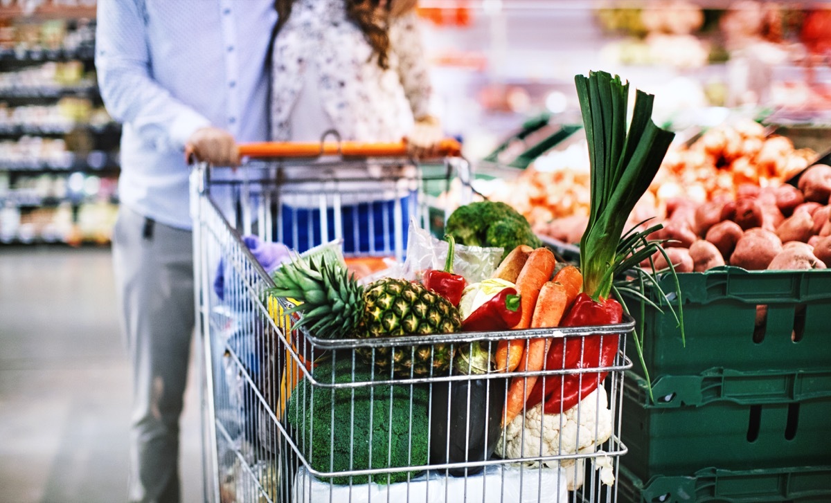 couple with filled grocery shopping cart