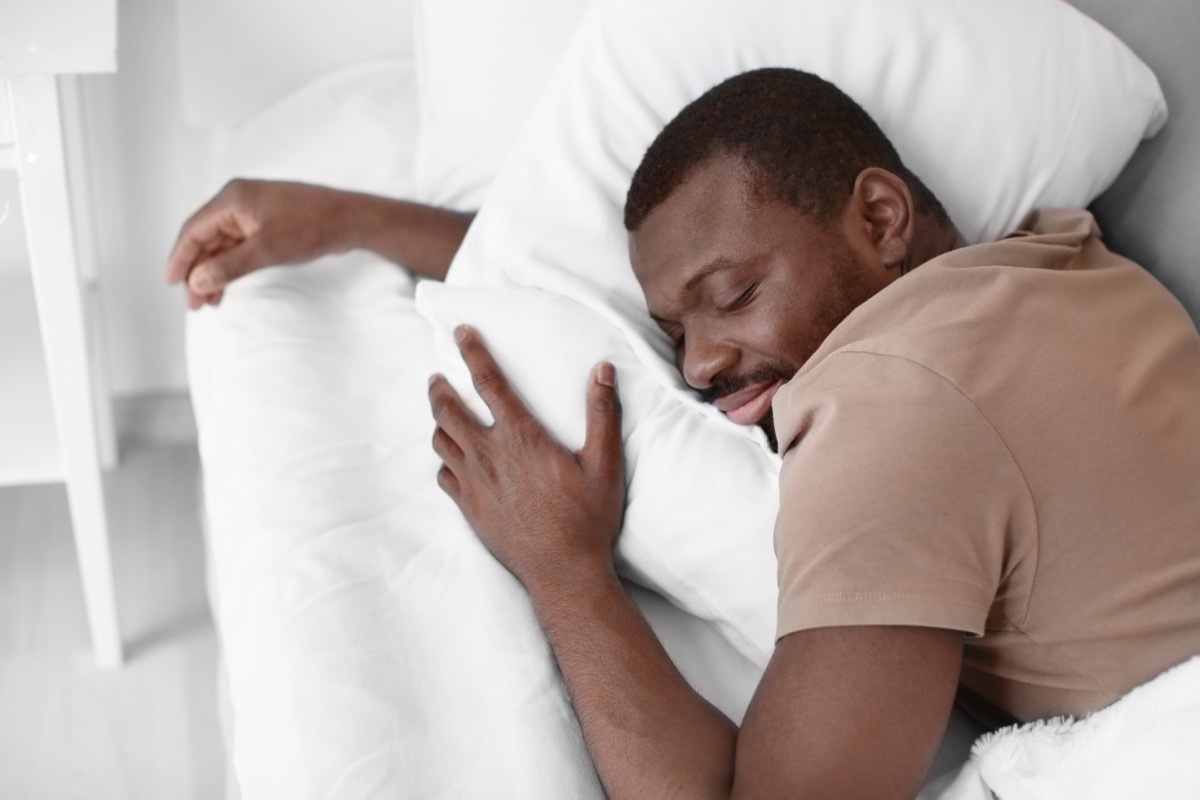 man sleeping in bed