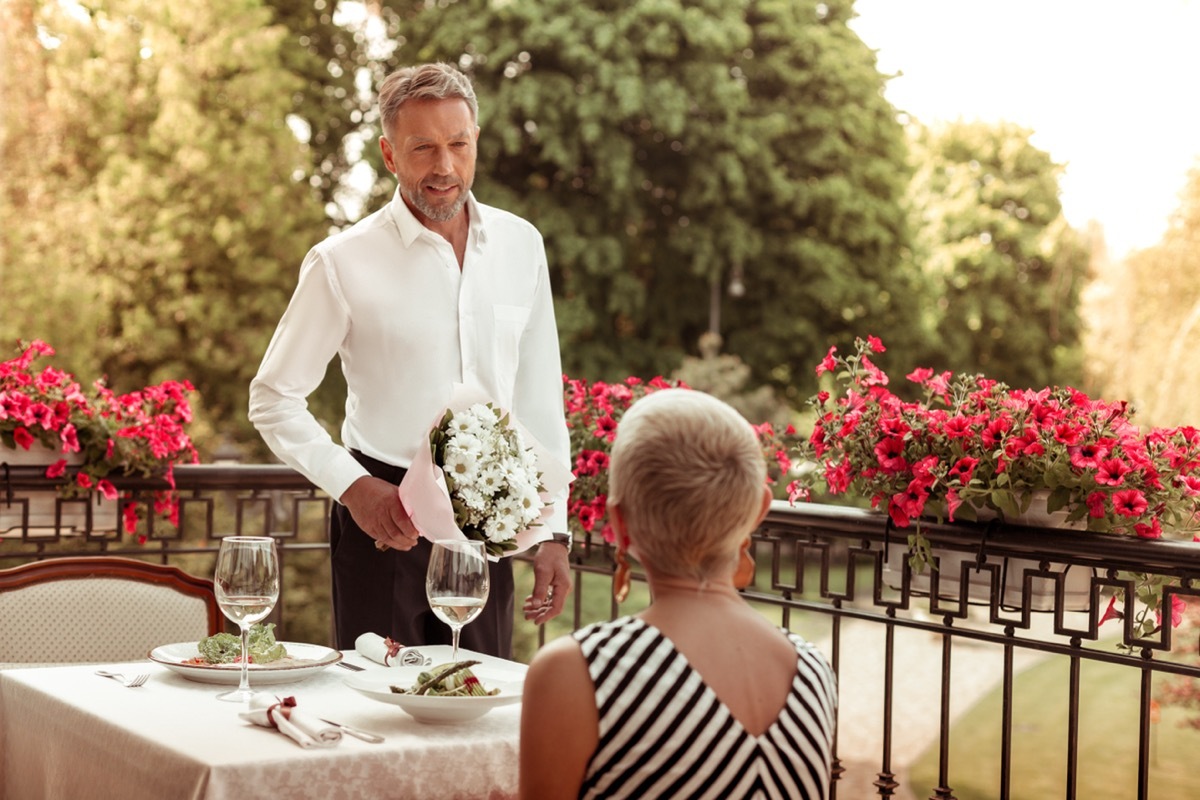 husband bringing flowers to wife