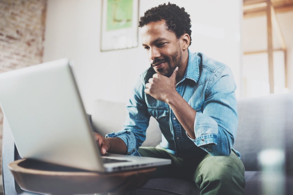 man reading literotica on a laptop