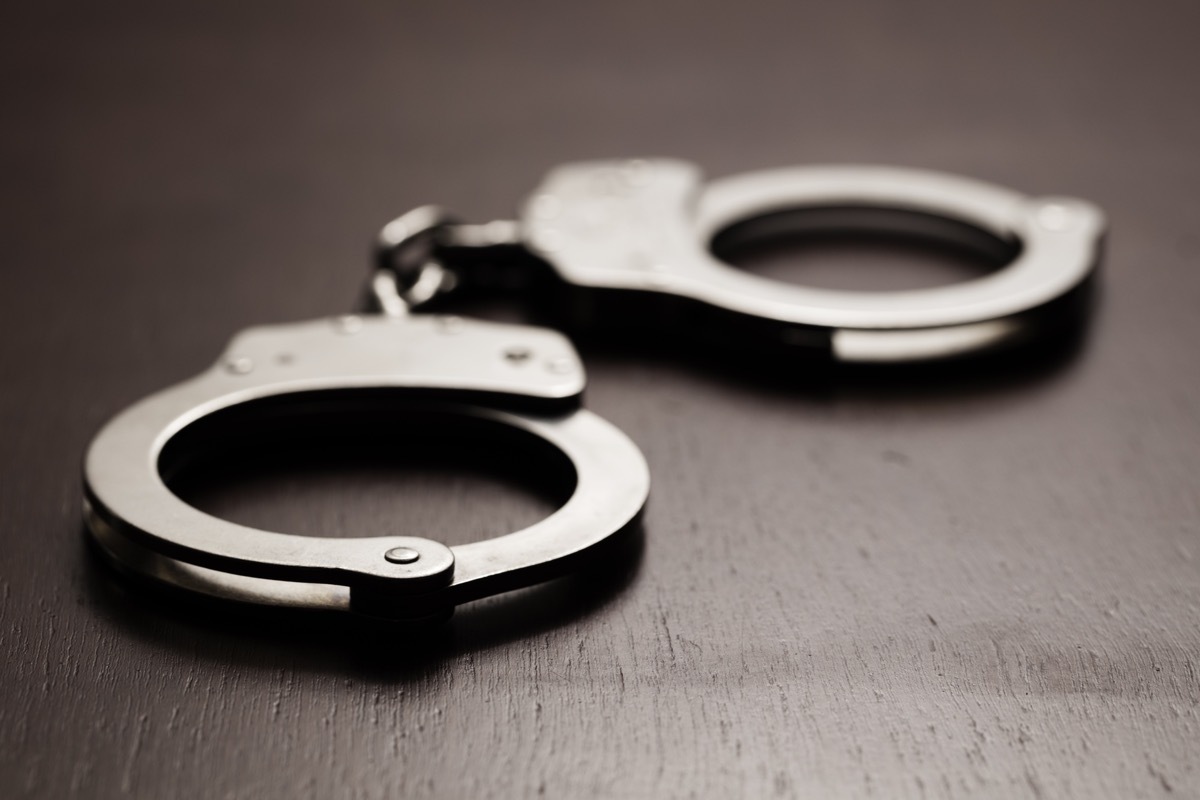 Pair of handcuffs sitting on a wooden desk