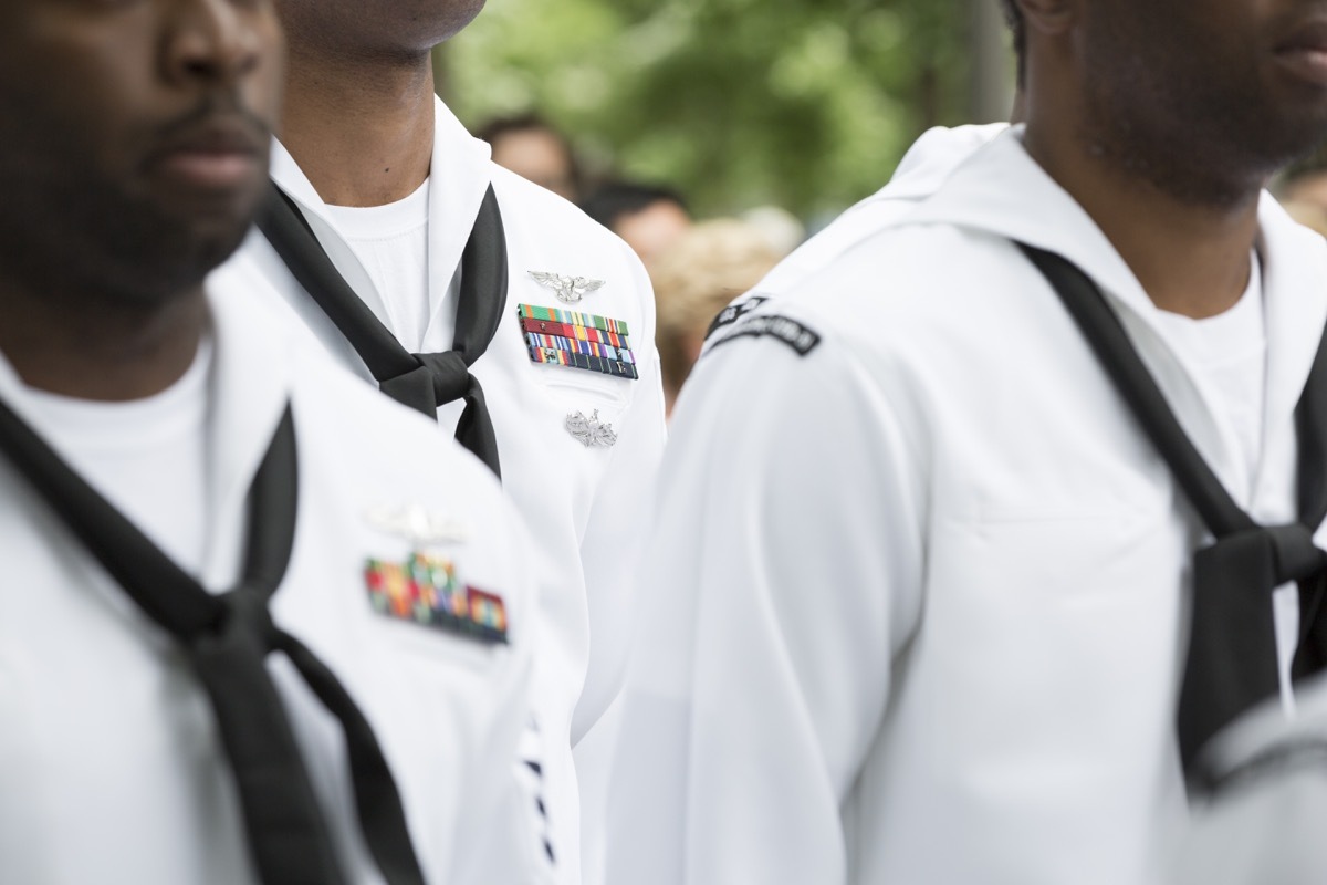 Close up of military medals, ribbons, and neck scarves worn by U.S. Navy personnel at the re-enlistment and promotion ceremony on National September 11 Memorial site