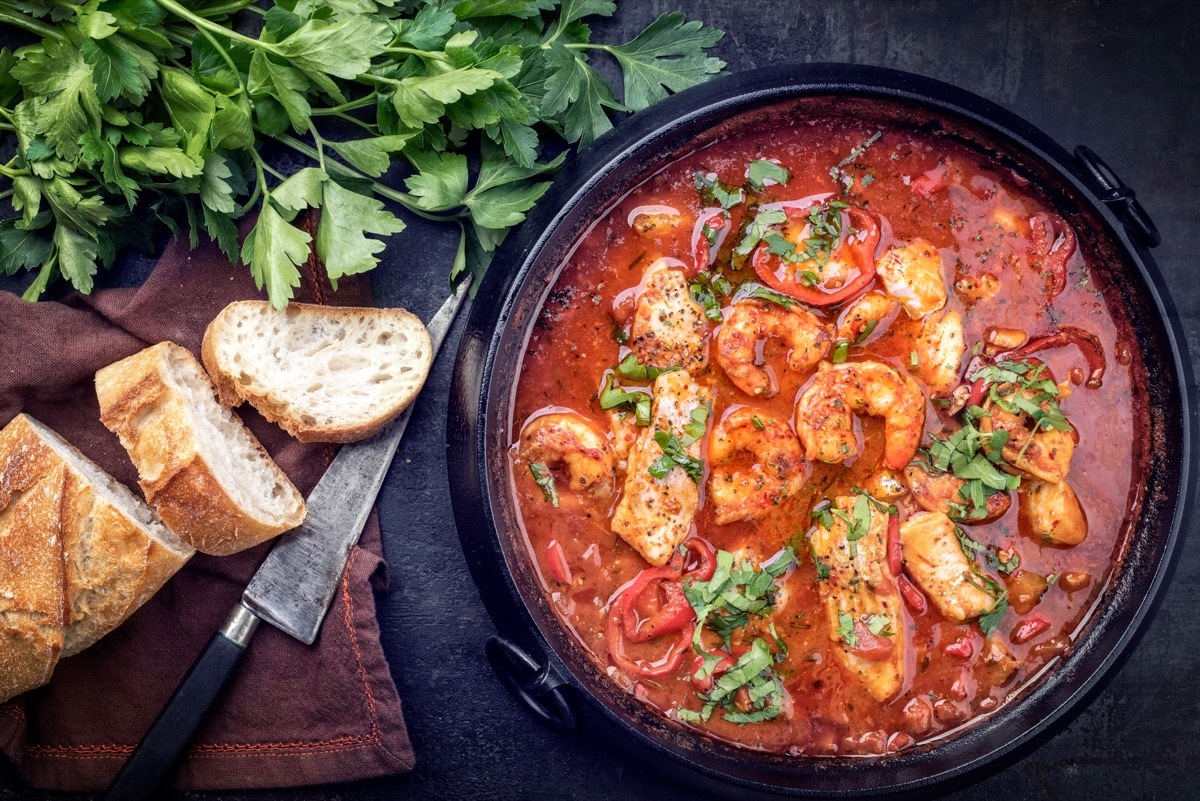 Bowl of gumbo with bread and cilantro