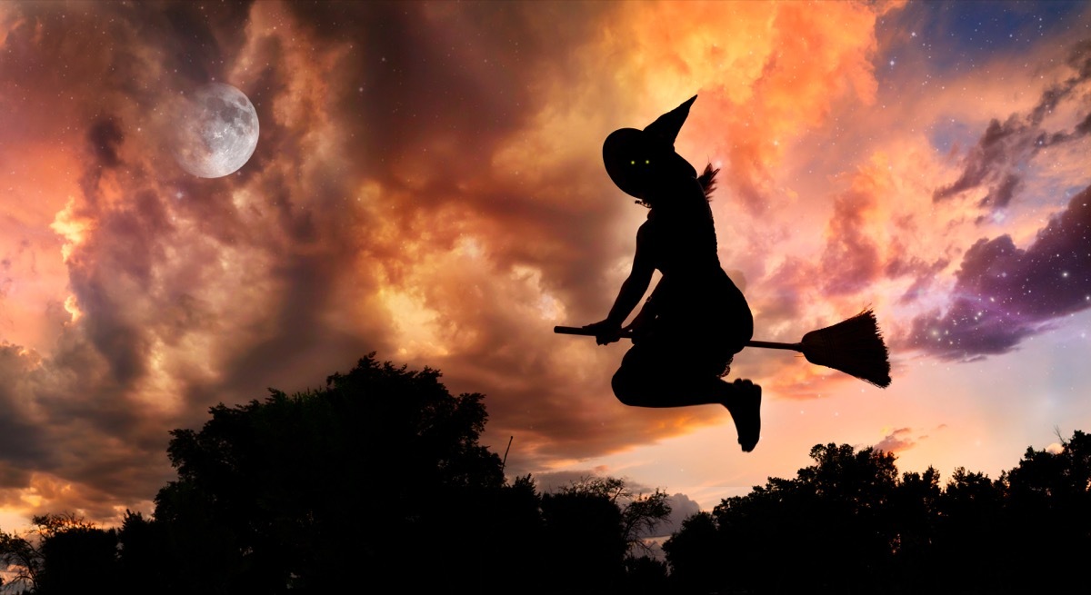 witch silhouette on bright orange sky