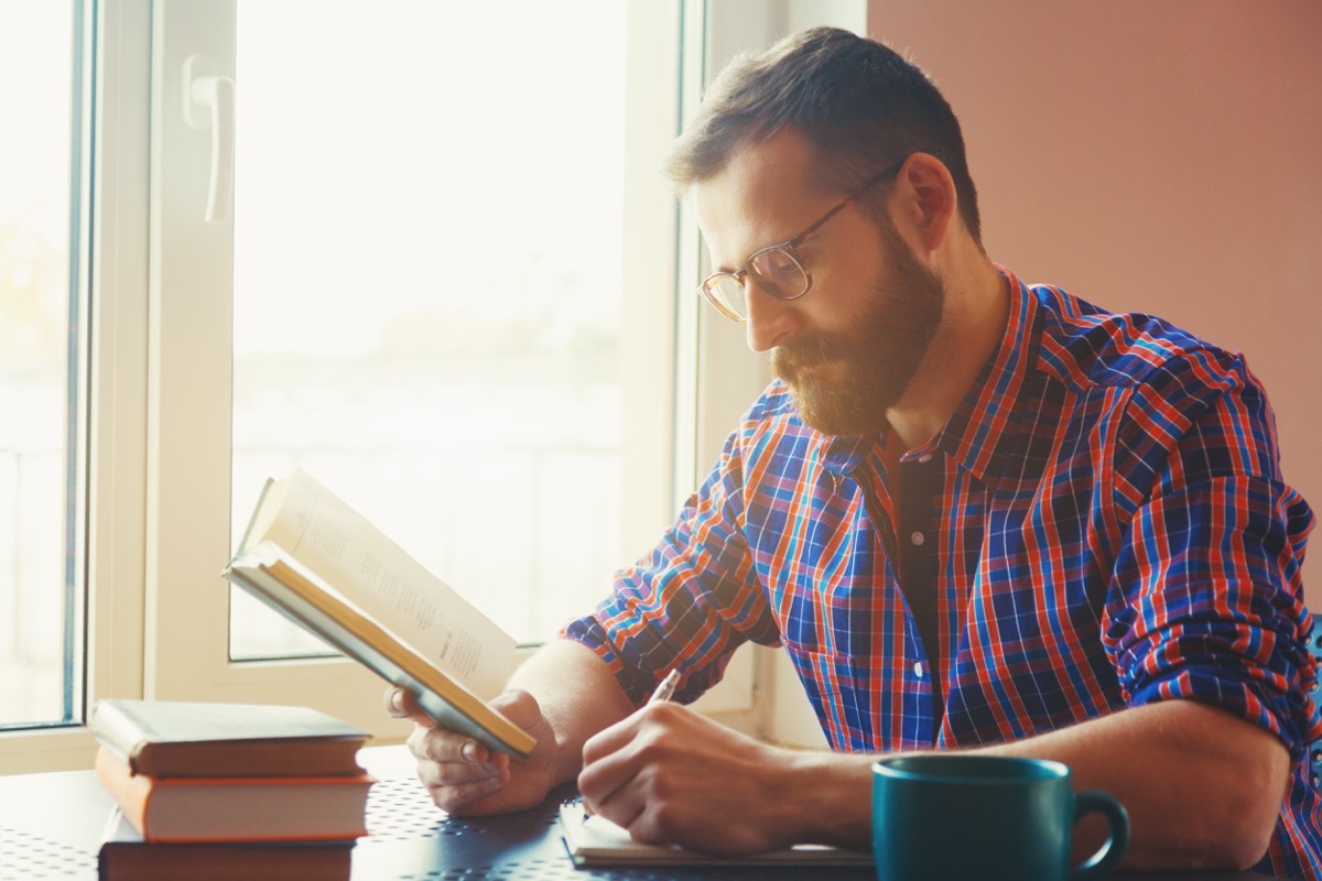 Man reading and studying at the table