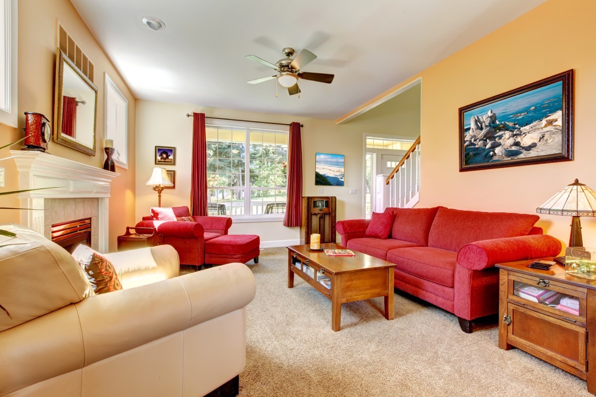 crowded living room with red furniture