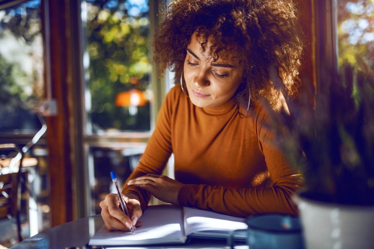 woman writing in a notebook