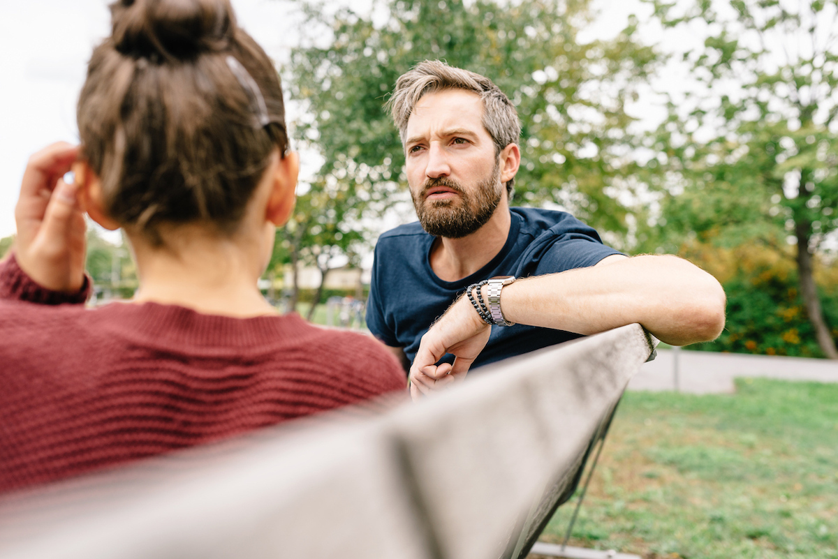 Father and Daughter talking outside on a bench