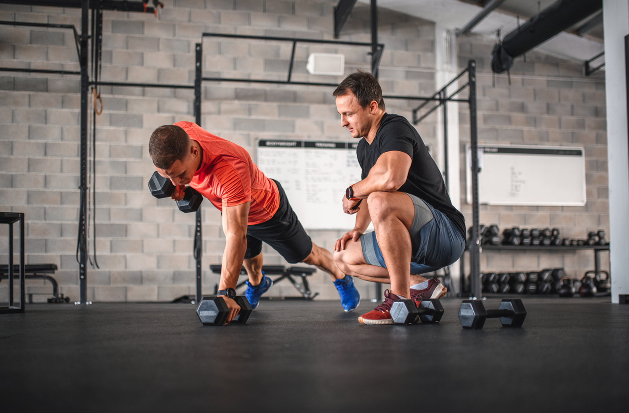 Man working out with fitness trainer.