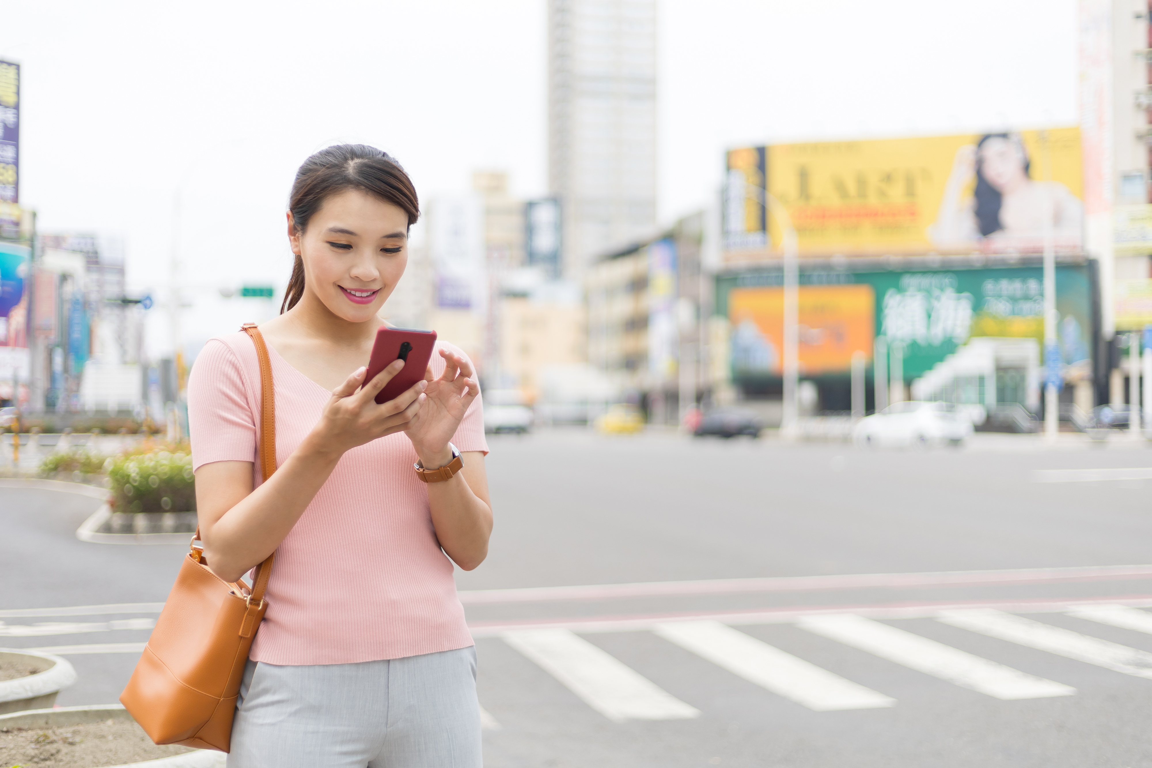 woman texting in the street