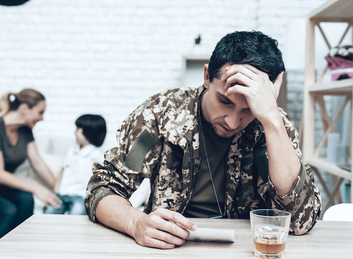 man looking at picture with shot of liquor - how does alcohol affect the brain