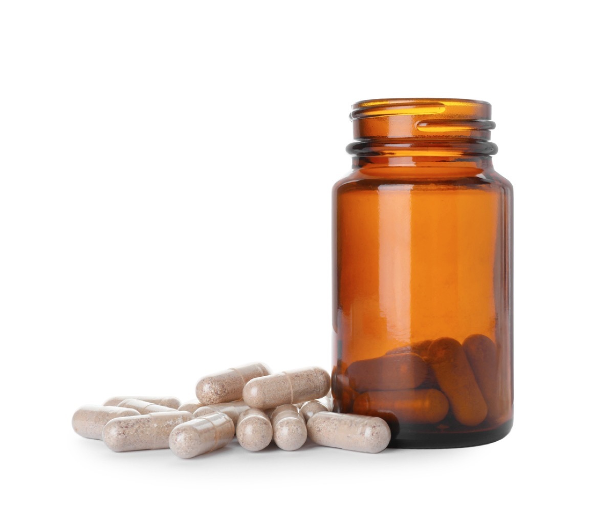 Gelatin capsules and bottle on white background