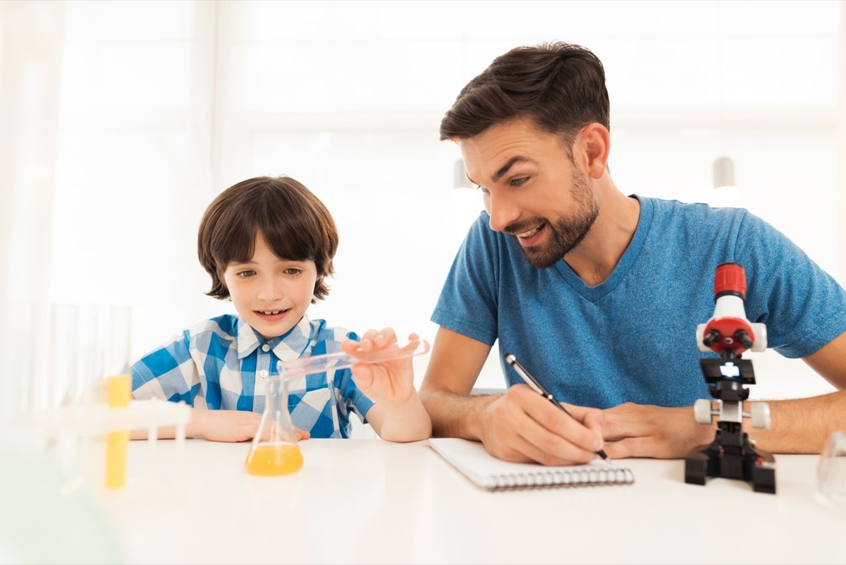 Father and son doing a science experiment together