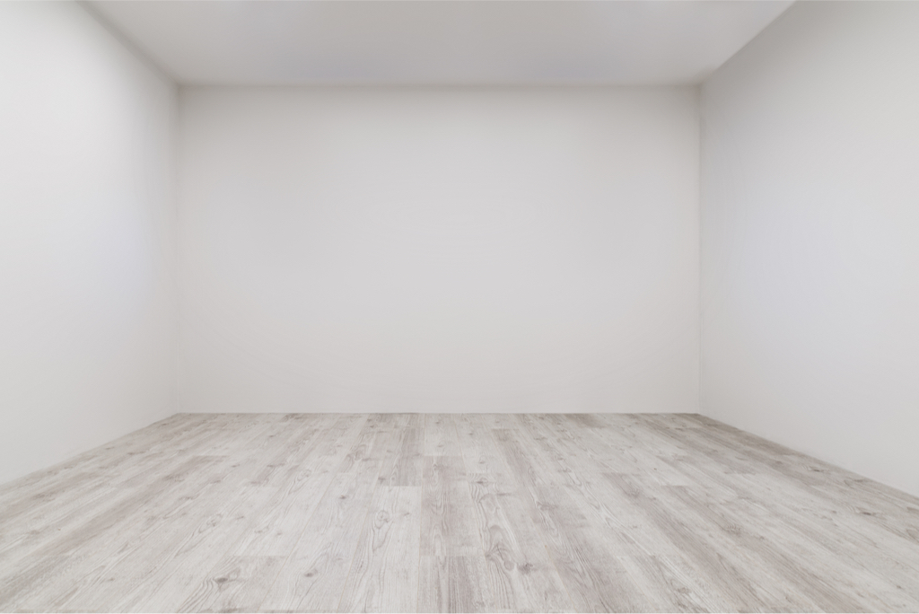 Empty room with white walls and wood floor