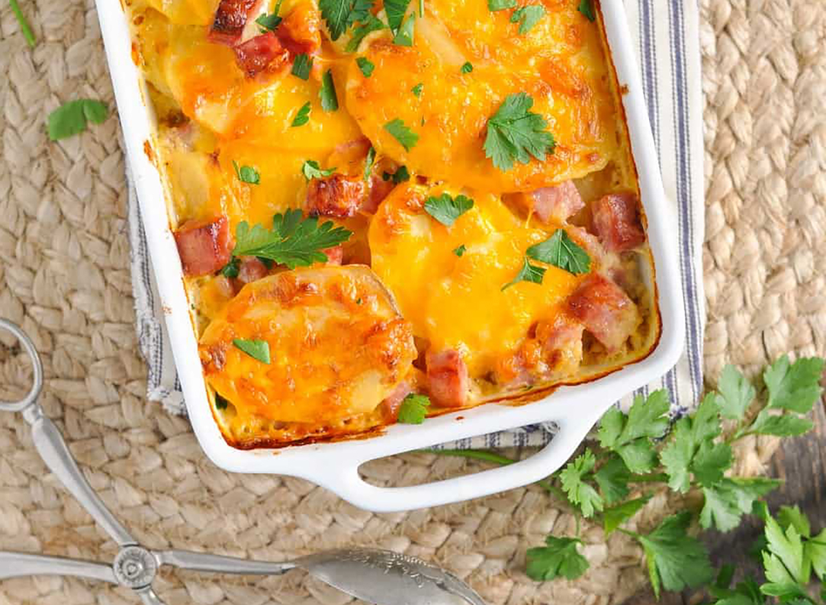 ham and cheese scalloped potatoes in white baking dish