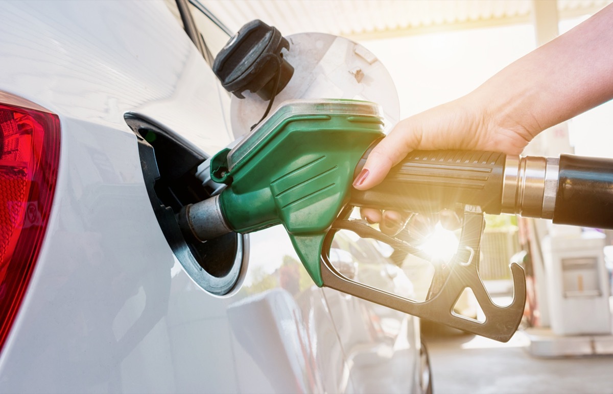 woman refueling her car at a gas station