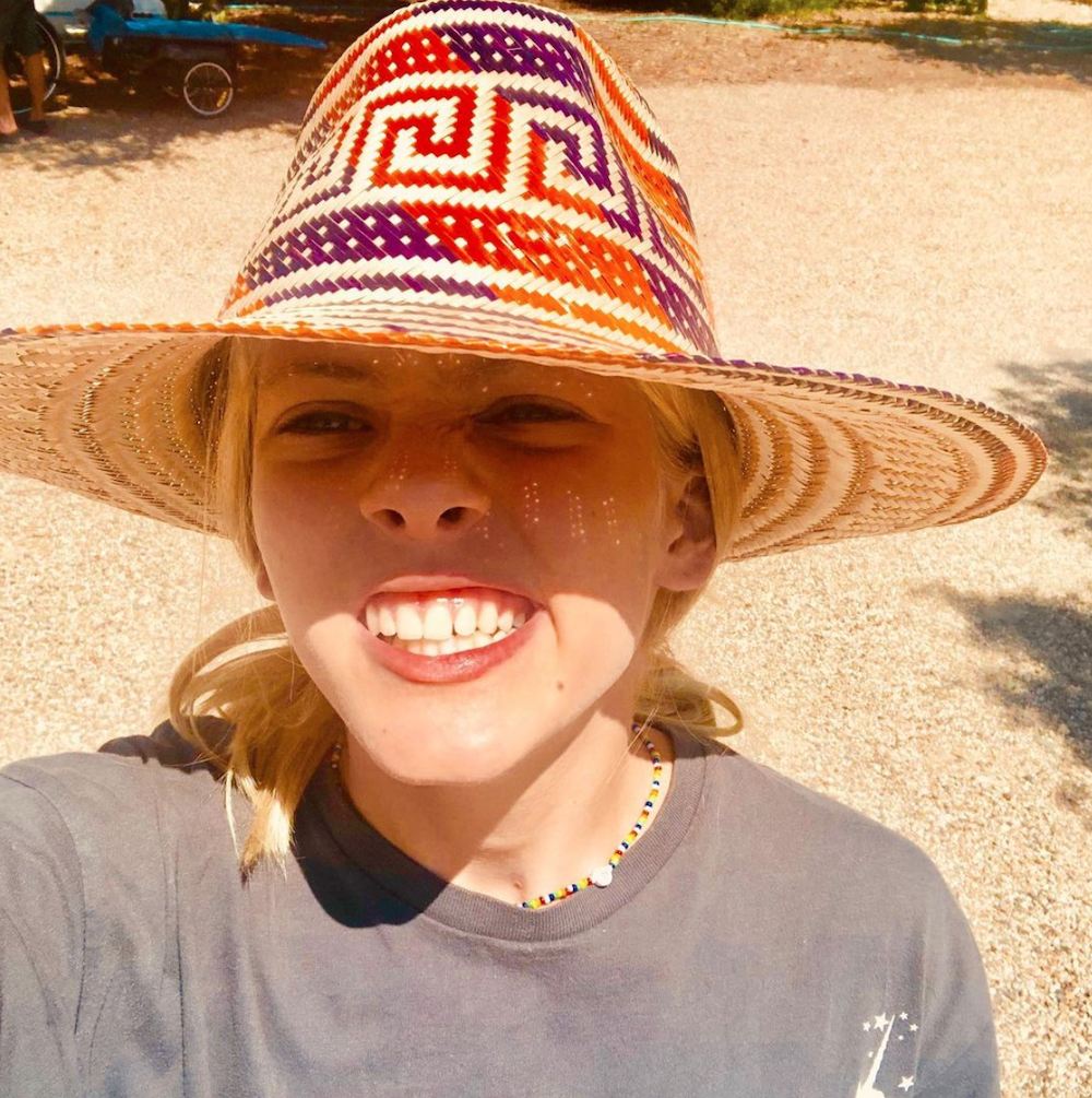 Hazel Moder posing for a selfie while wearing a large straw hat