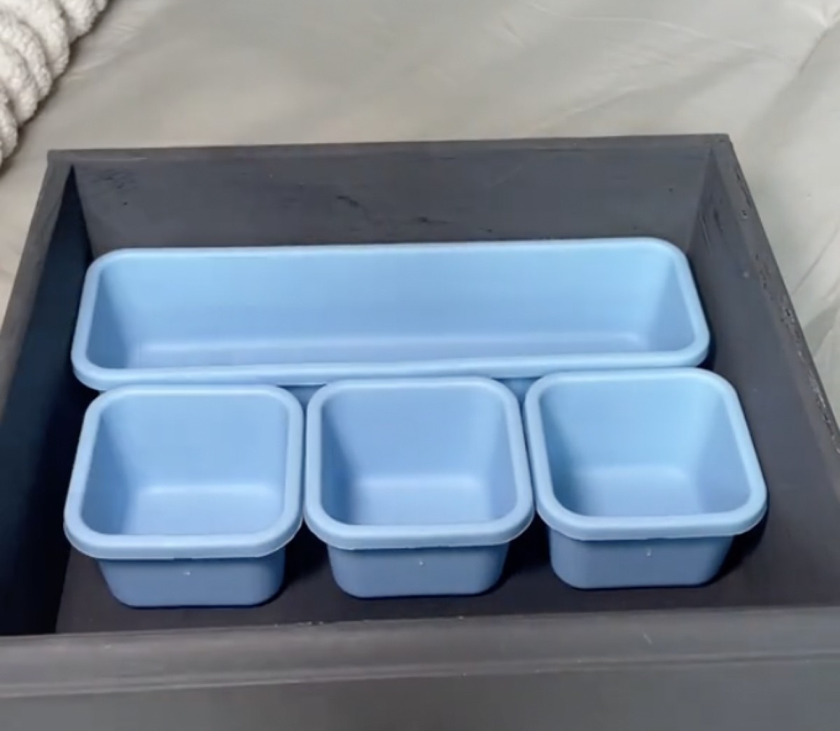 Five blue drawer organizers