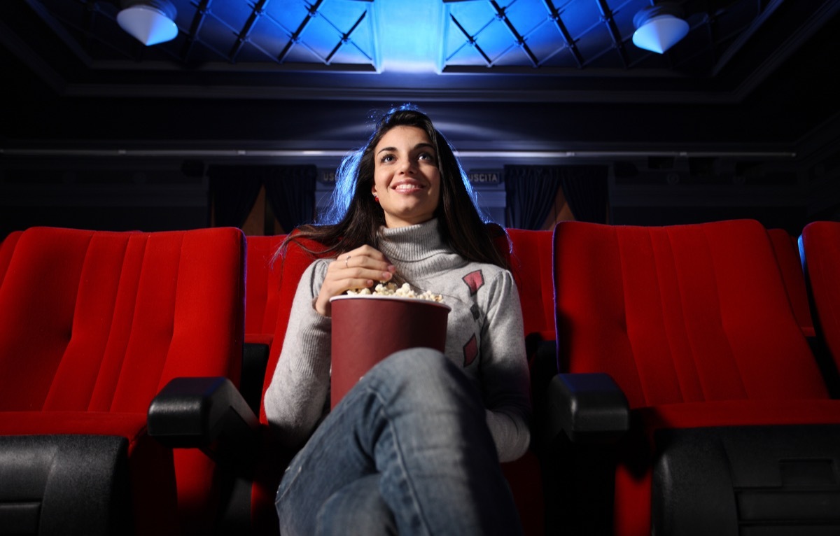 woman watching movie in movie theater alone exercises for mental health