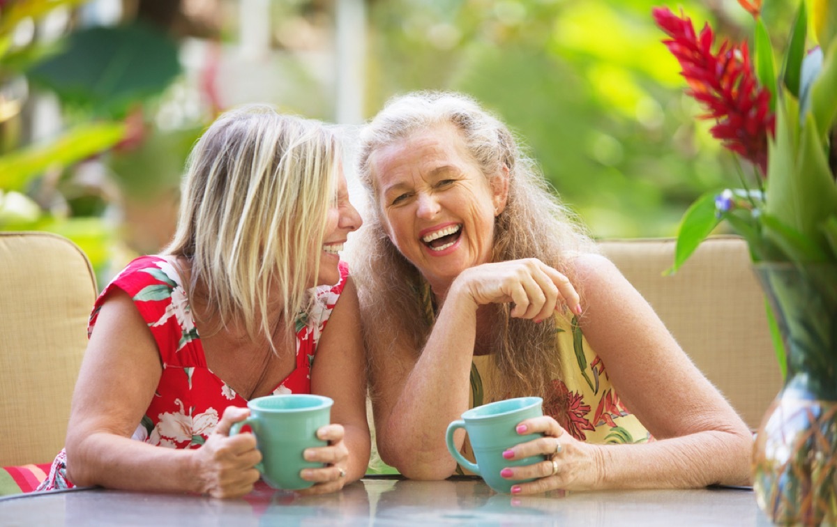 two older women laughing outside, female friend