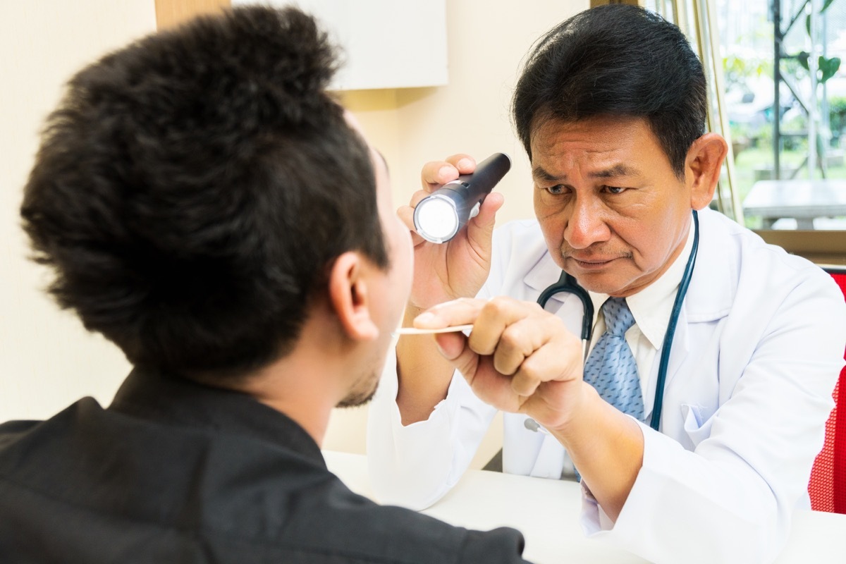 Doctor Examining a Patient's Mouth Tongue Health