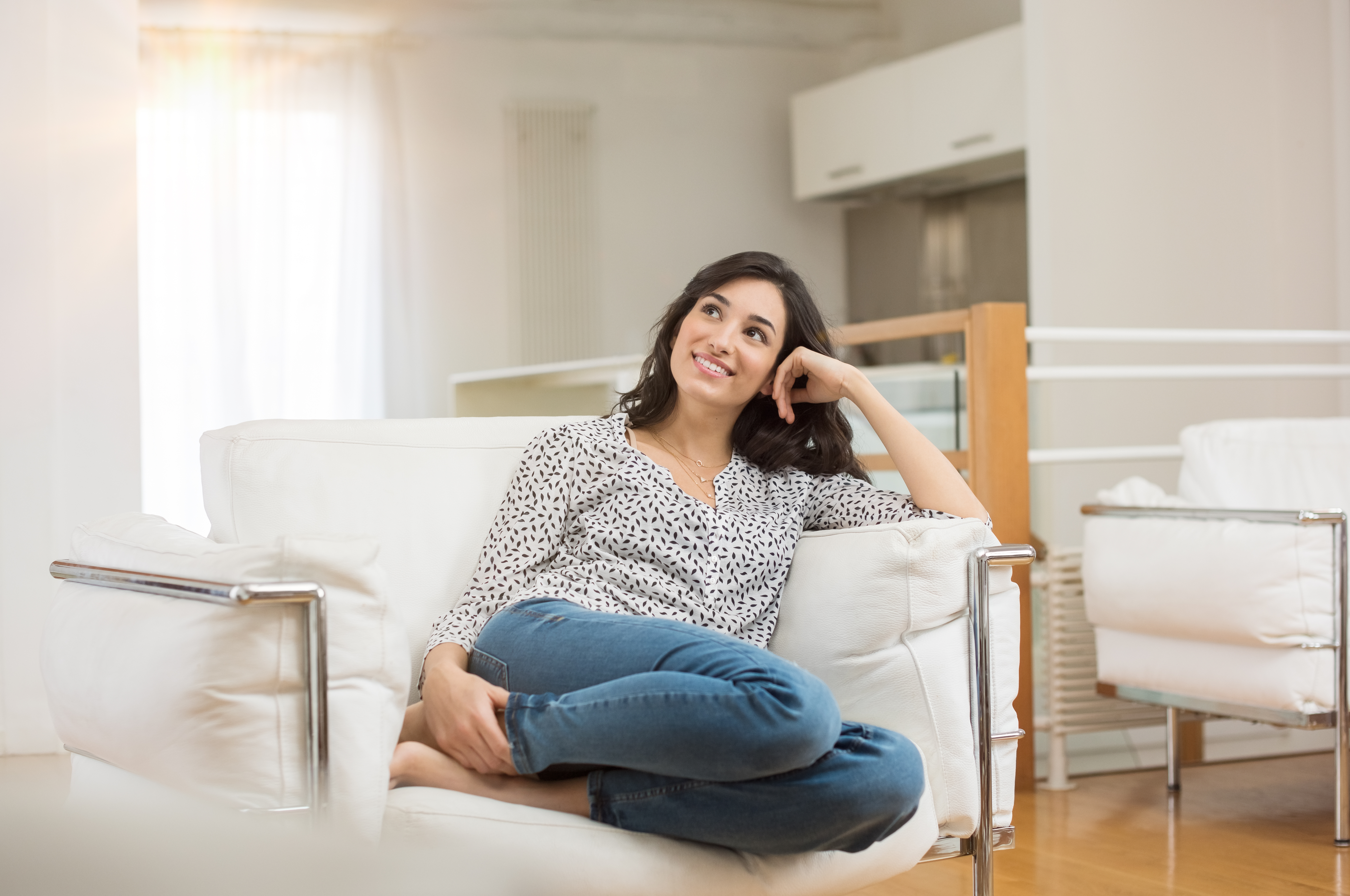 Confidence / Woman Sitting on Couch Smiling