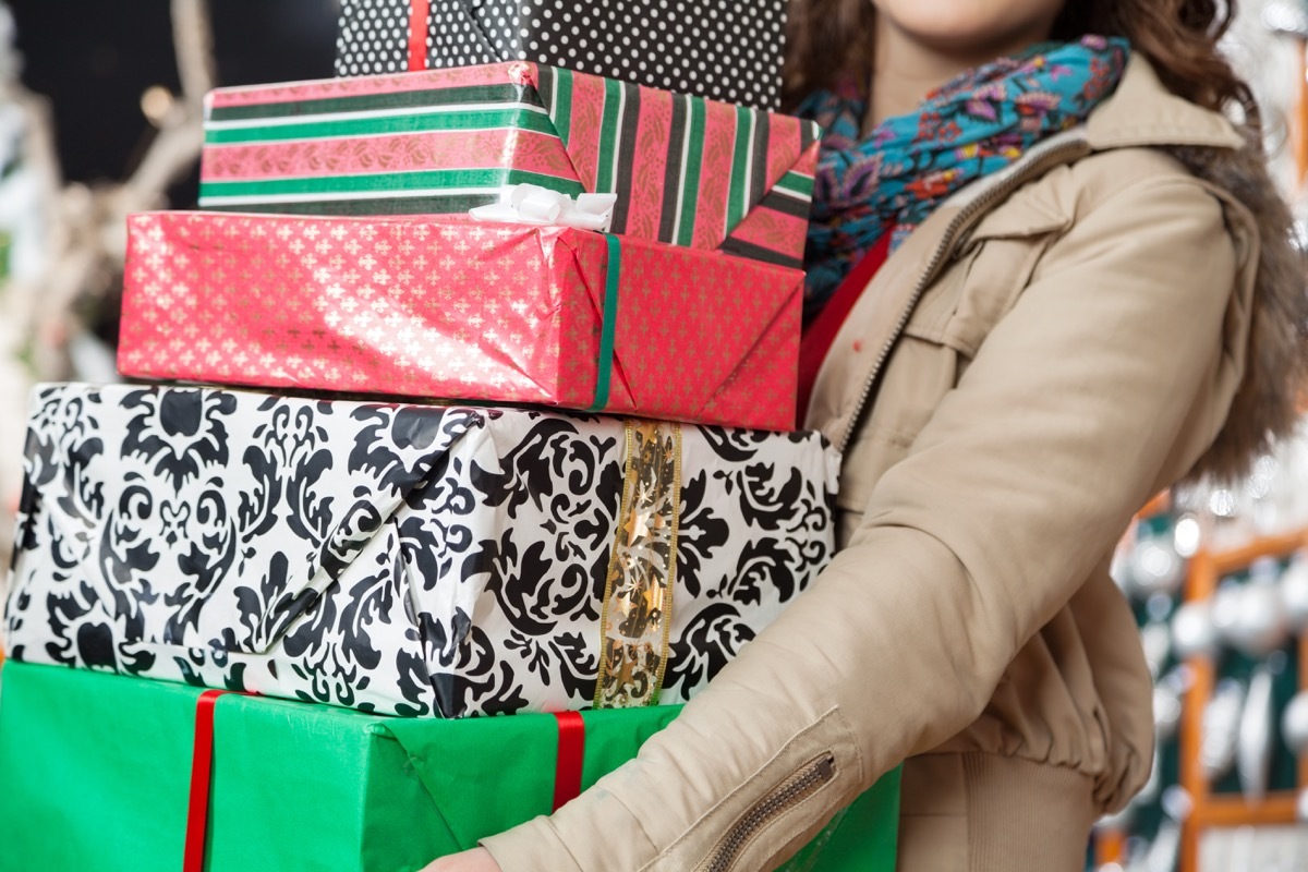 Woman holding a pile of wrapped presents