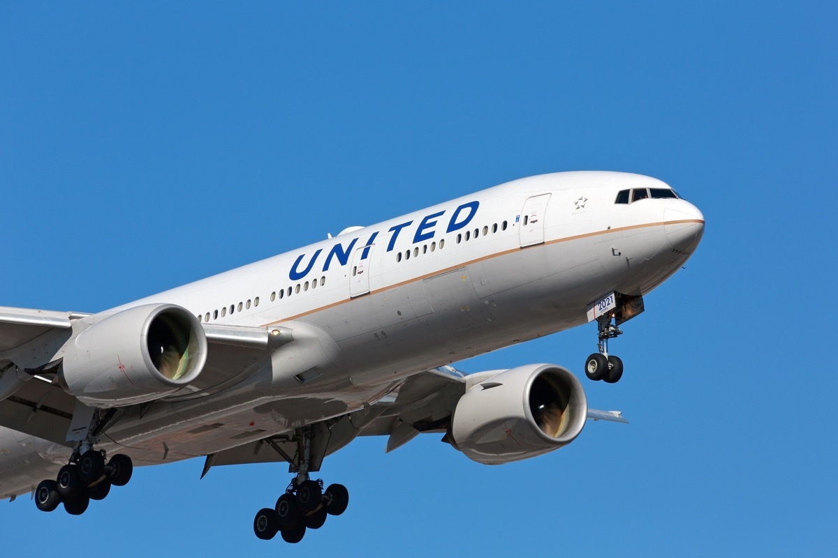 CHICAGO, ILLINOIS / USA - March 10, 2018: A United Airlines passenger aircraft - Boeing 777 - arriving at Chicago O'Hare International Airport on a sunny morning.