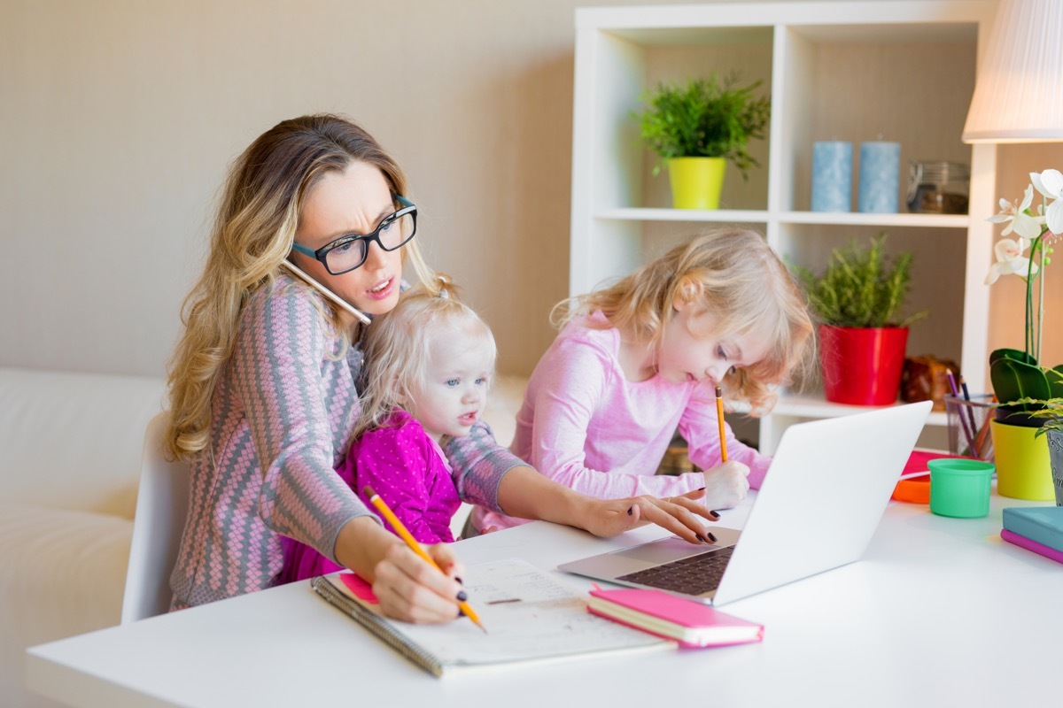 busy mom trying to work with children