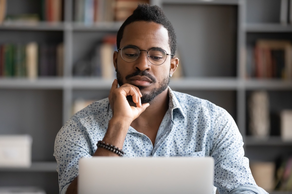 Man on his laptop deep in thought