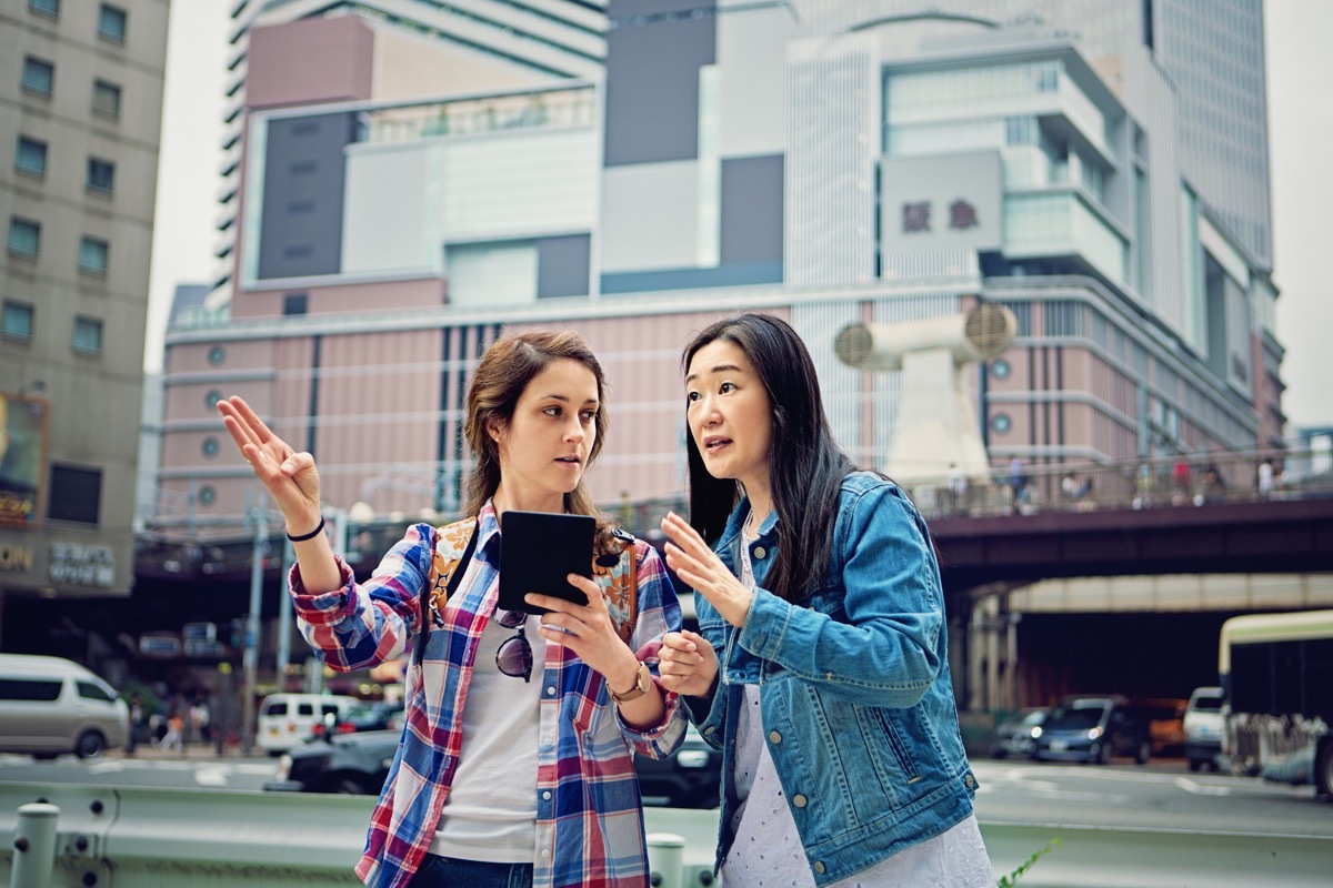 Young caucasian girl is lost in Japan and asking local mature woman for help