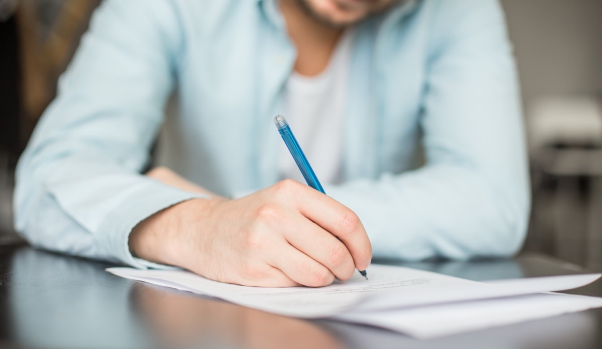 Man writing at the desk