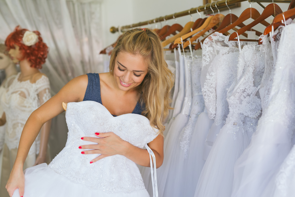 woman shopping for a wedding dress, wedding planner secrets